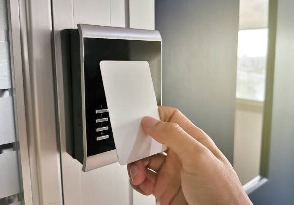 Hand using Key card;access control concept